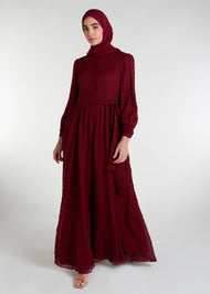 This Crinkled Chiffon Maxi Burgundy is fully lined, lightweight, and airy. It also has the option of a belt and pockets for added convenience. The chiffon material adds texture.