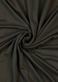 Effortless to style and incredibly comfortable to wear, with a subtle sheen. The medium-thick weight is soft, breathable, fully opaque and durable. Jersey works well in all climates, can be worn without an under scarf or pins, and makes a great option for working out. Dark green hue.