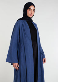 Waist pleats create a flowy silhouette, accompanied by wide sleeves and a stylish kimono style. The denim blue color adds to its overall appeal, while pockets provide functionality.