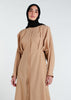 This Maxi Shirt Dress Sand features cuffed sleeves and pockets, giving the appearance of a tucked-in shirt and skirt when it is actually a one-piece outfit. Pleats at the waist create a cinch, while the top half remains loose for a comfortable fit. The dress is cut in an A-line style. Neutral beige tone.