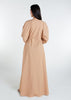 This Maxi Shirt Dress Sand features cuffed sleeves and pockets, giving the appearance of a tucked-in shirt and skirt when it is actually a one-piece outfit. Pleats at the waist create a cinch, while the top half remains loose for a comfortable fit. The dress is cut in an A-line style. Neutral beige tone.