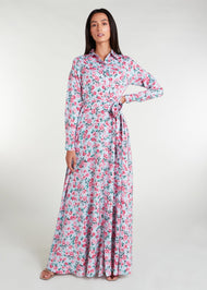 Featuring a vibrant floral pattern with an optional belt for styling, standard collars, discreet side pockets, and buttons all the way down, this maxi dress is perfect for any occasion. It is also suitable for nursing, making it a practical and stylish choice for any mother. Light blue base colour with pink roses and green thorns and leaves.