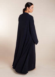 This elegant Two Piece Open Abaya set includes a Full Sleeve matching inner dress. Perfect for everyday wear, it can also be dressed up with accessories for an evening look. The open abaya can be worn as a maxi on its own or paired with the inner dress for a stylish ensemble. In navy.