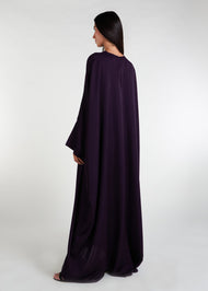 Our V Neck Kaftan in an intense aubergine hue features a front rise and cascading sides, creating a breezy and flowy aesthetic. This versatile piece is ideal for any summer occasion and paired with statement jewelry, it will elevate your overall look. 